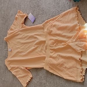 Stars above light orange top and short set